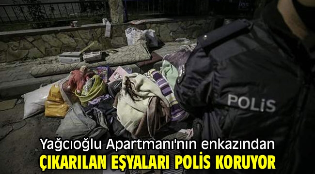 Yağcıoğlu Apartmanı'nın enkazından çıkarılan eşyaları polis koruyor