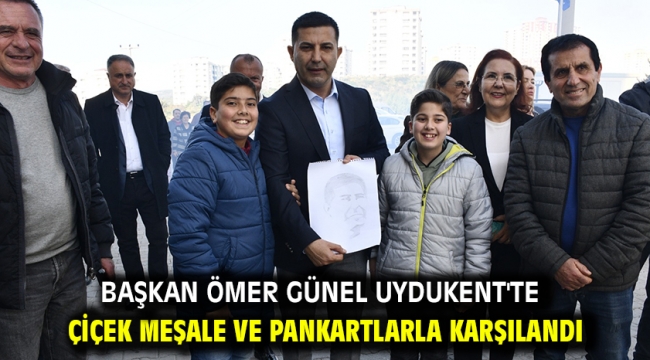 BAŞKAN ÖMER GÜNEL UYDUKENT'TE ÇİÇEK MEŞALE VE PANKARTLARLA KARŞILANDI